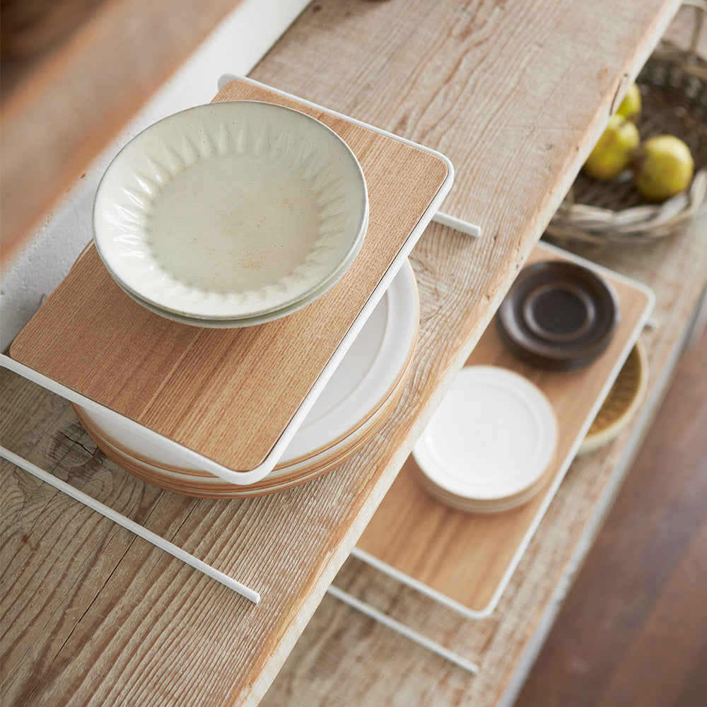 Yamazaki Home Dish Riser in small and large holding plates on a shelf.