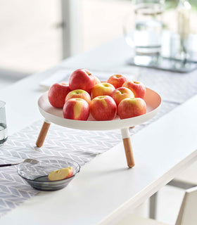 White Yamazaki Countertop Pedestal Tray with apples on top on a dining table view 6