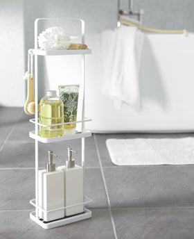 White Portable Shower Caddy displaying cleaning products in bathroom by Yamazaki Home. view 17
