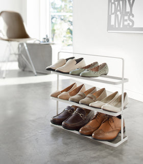 White Shoe Rack holding shoes in living room by Yamazaki home. view 2