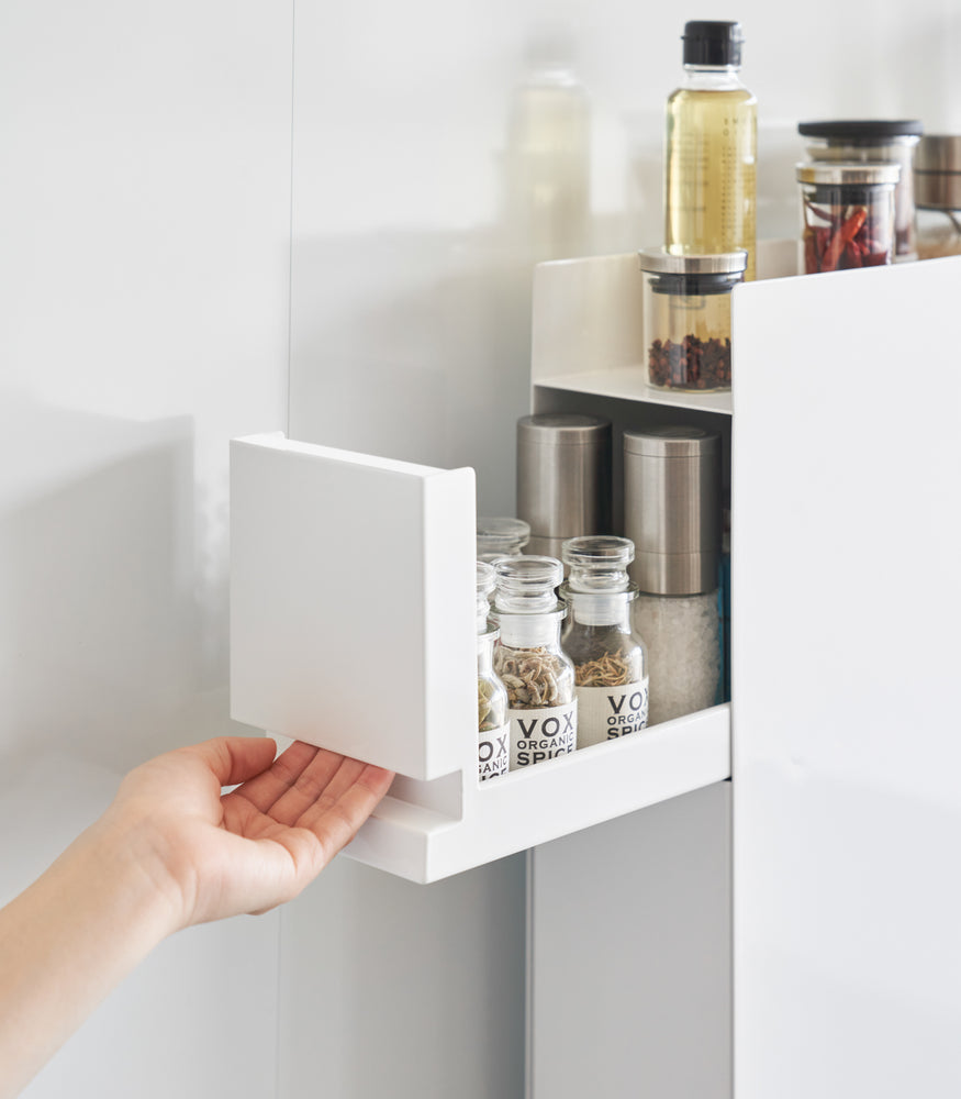 View 5 - Close up of top tier of white Yamazaki Home Two-Tier Sliding Drawer Seasoning Rack being opened