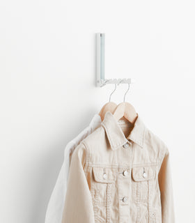 White Over-the-Door Hanger holding jackets on wall by Yamazaki Home. view 4