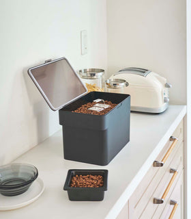 Side view of black Airtight Food Storage Container holding pet food on countertop by Yamazaki Home. view 22