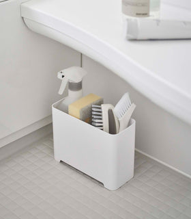 White Yamazaki Self-Draining Bathroom Organizer filled with cleaning supplies view 4
