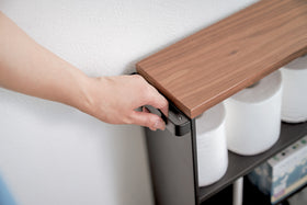 Close up view of black Rolling Storage Cart holding toilet paper by Yamazaki Home. view 14