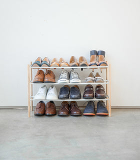 Front view of Expandable Shoe Rack holding shoes by Yamazaki Home. view 4