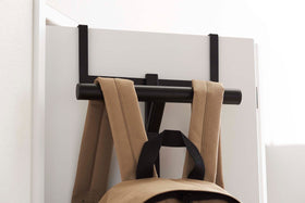 Close up front view of Black Kids' Backpack Hanger holding a backpack on door by Yamazaki Home. view 12