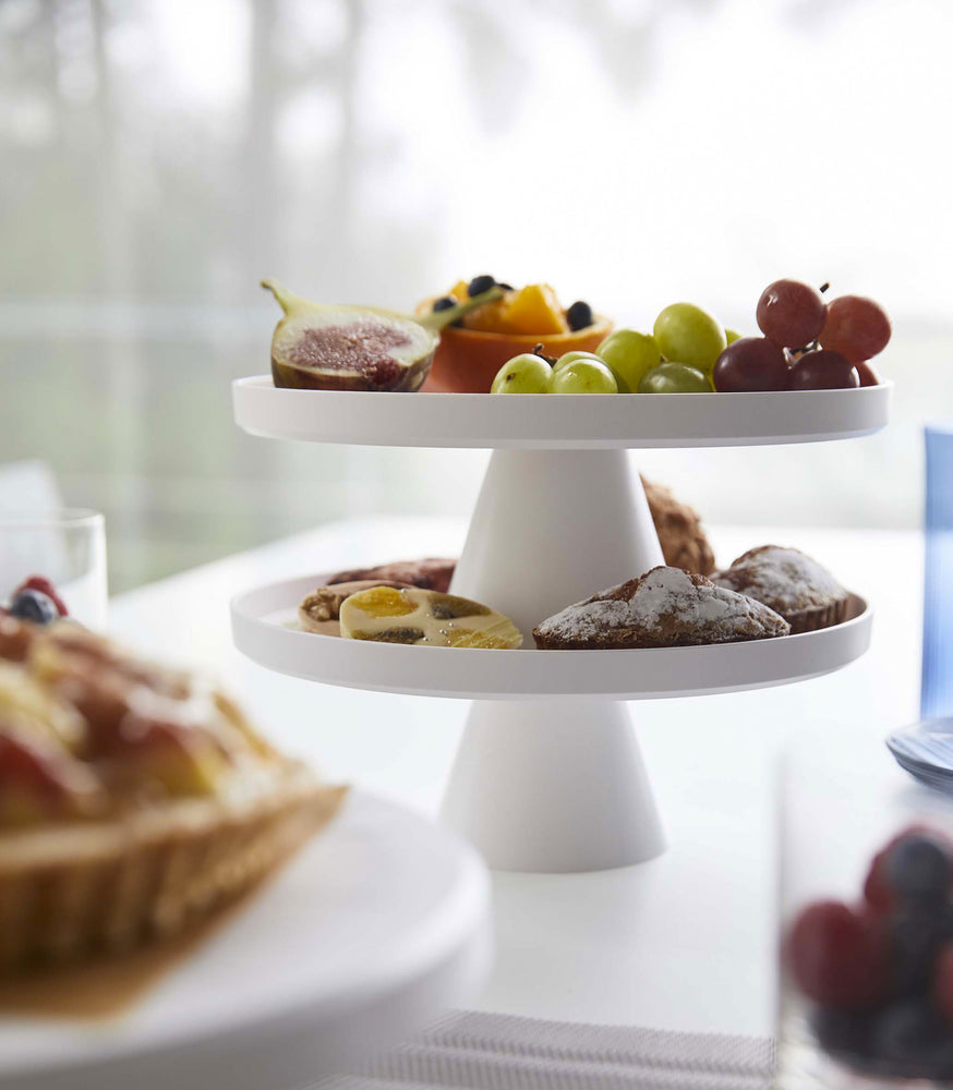 View 5 - Front view of white Stackable Serving Stand stacked holding pastries and fruit by Yamazaki Home.