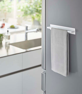 White Magnetic Kitchen Towel holding towel on kitchen fridge by Yamazaki Home. view 3