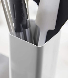 Close up view of white Utensil Holder holding cooking utensils by Yamazaki Home. view 5