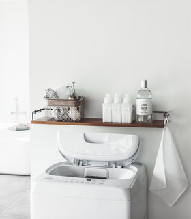 Front view of Wall-Mounted Shelf holding cleaning items in laundry room by Yamazaki Home. view 7