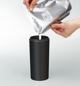 Front view of black Shampoo Dispenser getting filled with shampoo on white background by Yamazaki Home. view 21