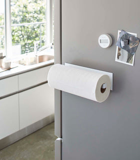Horiztonal White Magnetic Paper Towel Holder holding paper towels in kitchen by Yamazaki Home. view 2