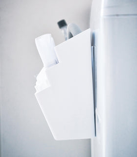 Close up side view of Magnetic Storage Caddy holding cleaning items by Yamazaki Home. view 5