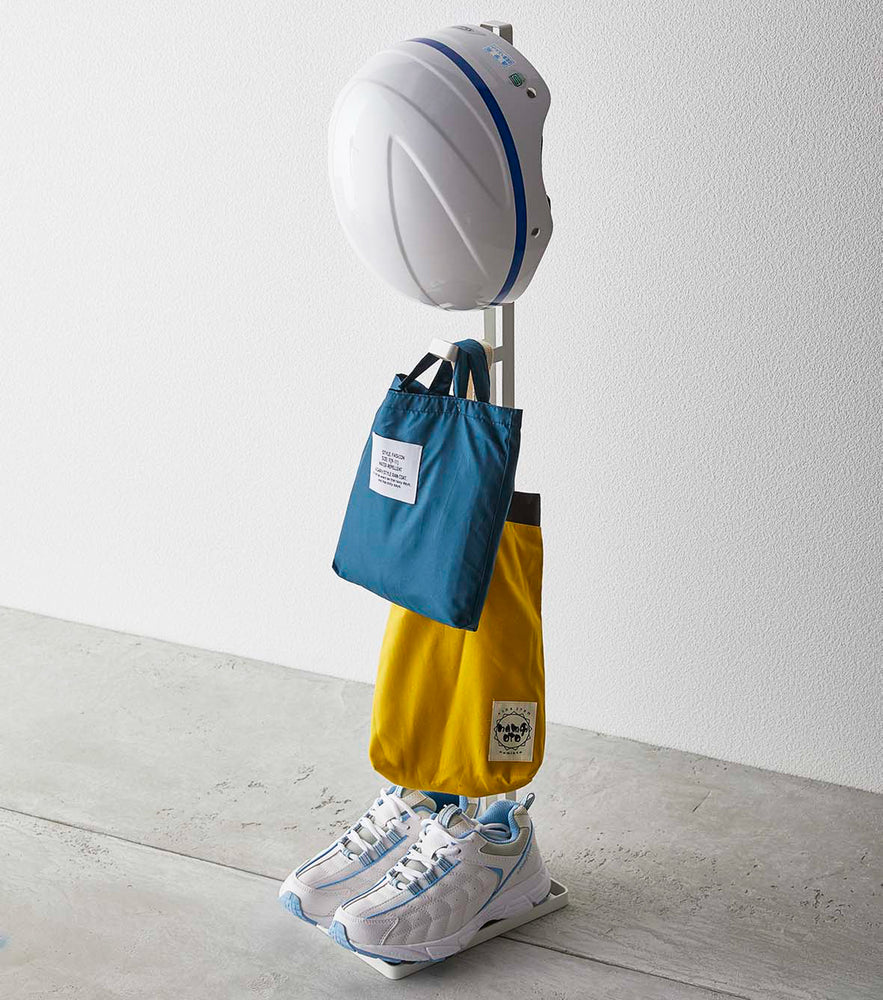 View 2 - White Kids' Helmet Stand holding bags, helmet, and sneakers by Yamazaki Home.