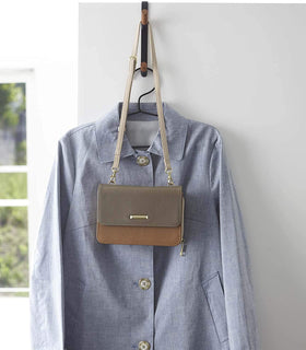 Front view of black Over-the-Door Hook holding shirt and purse by Yamazaki Home. view 12