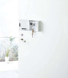 Open white Square Magnetic Key Cabinet with Hooks holding keys on door by Yamazaki Home. view 3