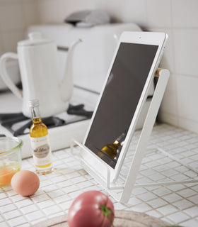 Side view of white Tablet and Cookbook Stand holding a tablet by Yamazaki home. view 3