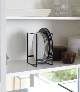 Black Dish Storage Rack holding plates in cabinet by Yamazaki Home. view 6
