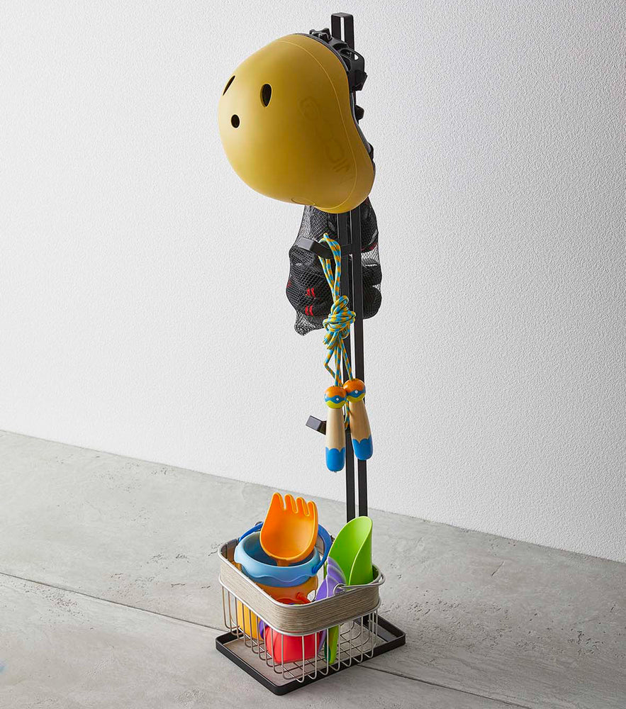 View 8 - Black Kids' Helmet Stand holding a helmet and toys by Yamazaki Home.