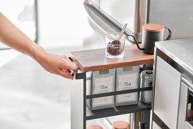 Partial front view of black Rolling Storage Cart holding tea and coffee in kitchen by Yamazaki Home. view 11