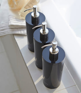 Aerial view of Yamazaki Home black Shampoo, Conditioner, and Body Soap dispensers in bathroom. view 12