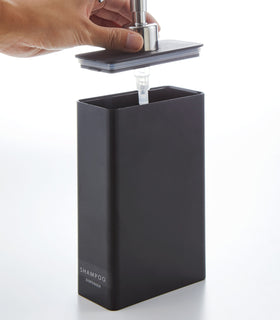 Black Shampoo Dispenser with top removed on white background by Yamazaki Home. view 16