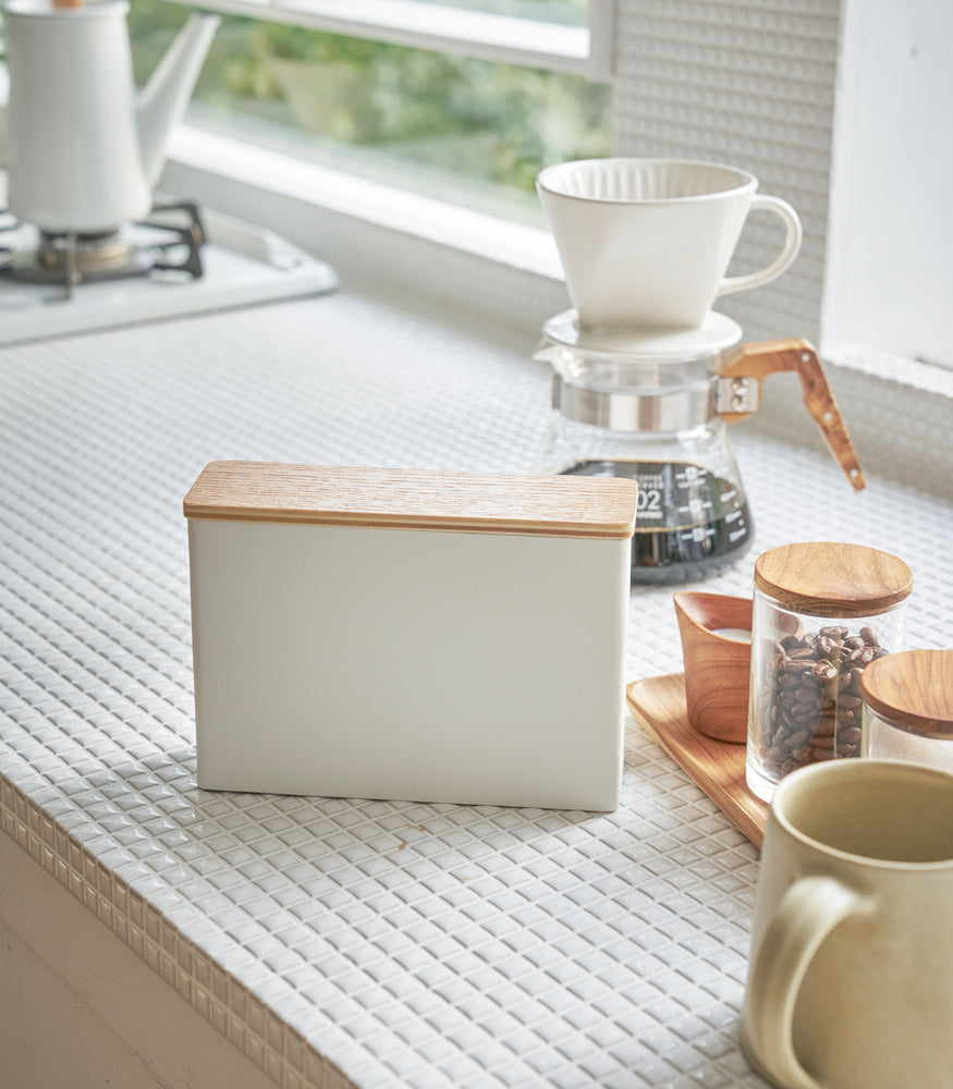 View 2 - Front view of closed white Size 01 + 02 Wood-Accent Coffee Filter in kitchen by Yamazaki Home.