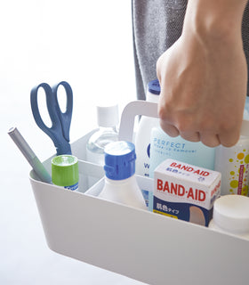 Close up of white Storage Caddy holding first-aid materials on white background by Yamazaki Home. view 3
