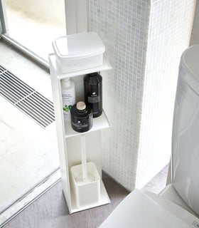 Yamazaki Home white Toilet Organizer holding wet wipe holder, cleaning products, and toilet brush in bathroom. view 4
