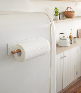 Magnetic Paper Towel Hanger holding paper towel on kitchen fridge by Yamazaki Home. view 4