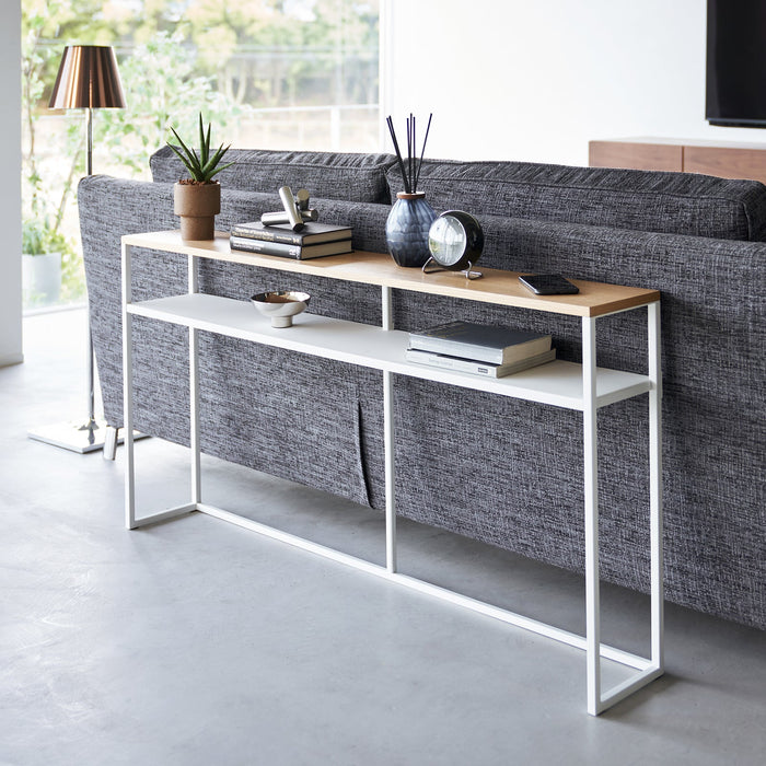 white long console table behind of couch