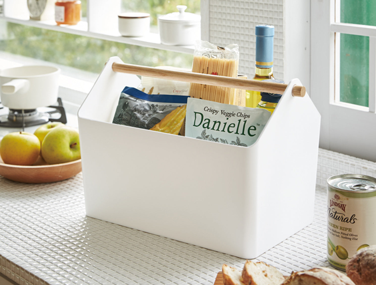 Favori Caddy from Yamazaki Home filled with dry goods, Oyster Bay wine, and other materials for a delicious dinner. Prepare for the New Year with Osoji. Caddy set on a modern kitchen counter.