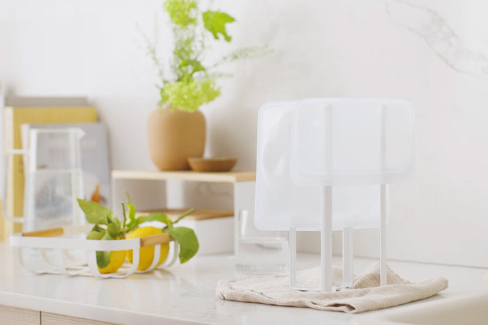 Collapsible Bottle Dryer by Yamazaki Home in white on a kitchen counter supporting a resealable bag.