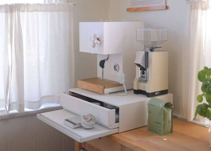 Coffee corner designed by Wah Wu featuring white countertop drawer from yamazaki home with a retro espresso machine and juicer on top. Cottage-core cozy kitchen. Minimalist. Danish