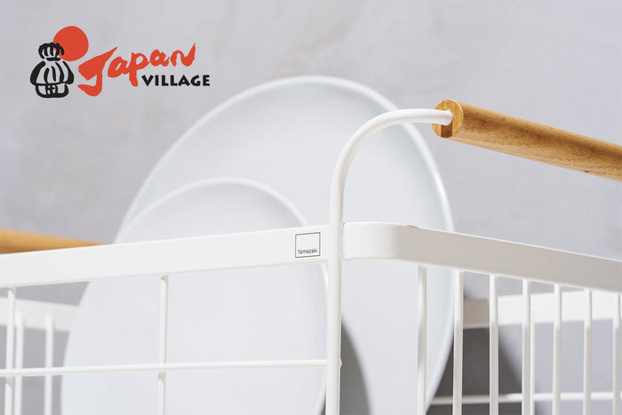 Close up image of Yamazaki Home TOSCA dish rack holding a large plate and a smaller plate with a white backdrop.