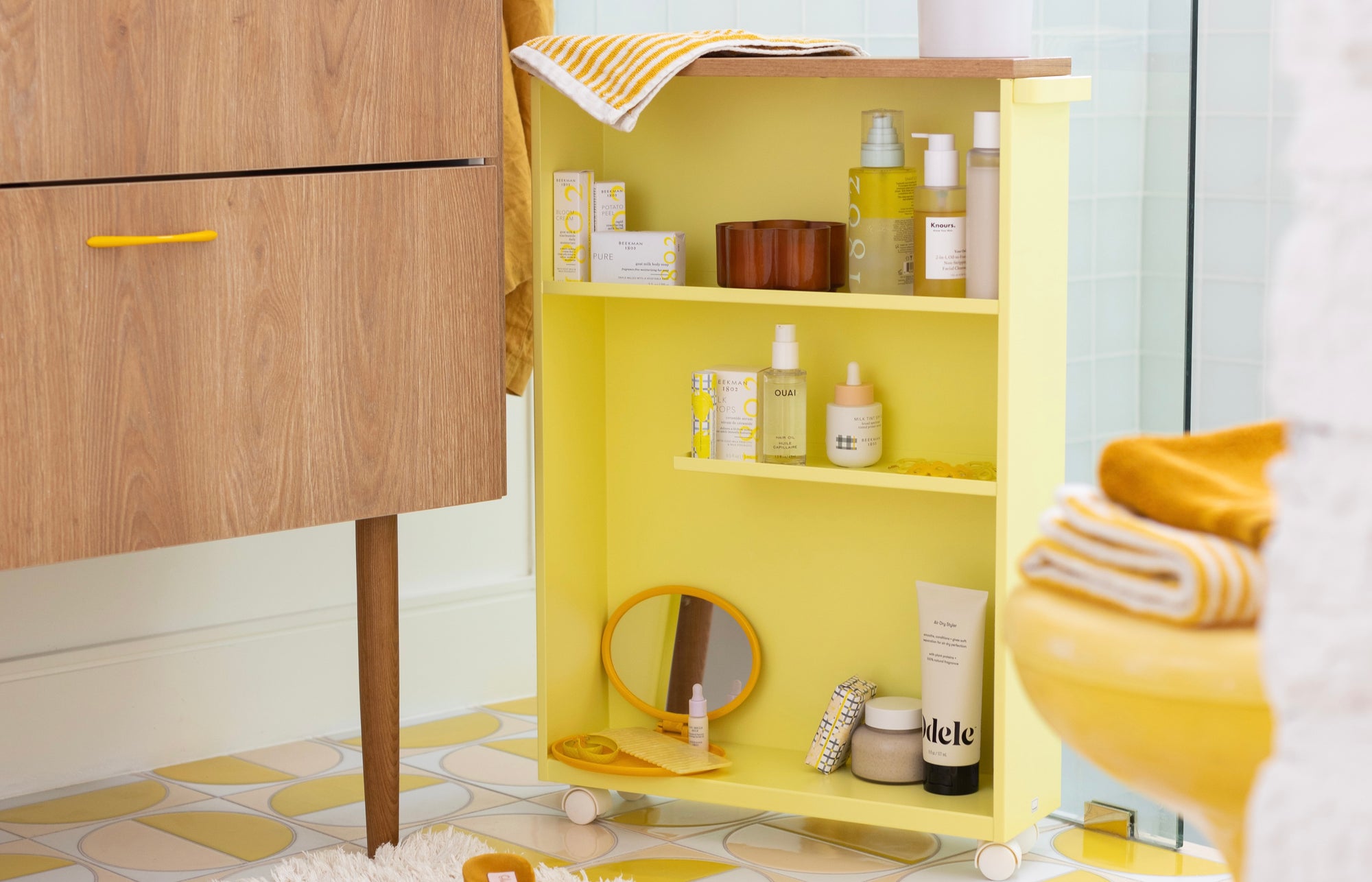 Yellow Pear Rolling Storage Cart in retro bathroom with yellow accents