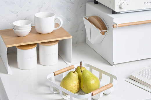 Breakfast nook with Yamazaki Home fruit bowl, cabinet rise, dry goods jars, and bread box in a modern kitchen 