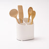 Sloped Utensil Holder holding kitchen utensils against a white background