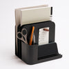 Black steel desk caddy from Apto organizing files, pens, office supplies, and post-its.