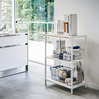 Yamazaki Home Steel storage shelf holding kitchen essentials.