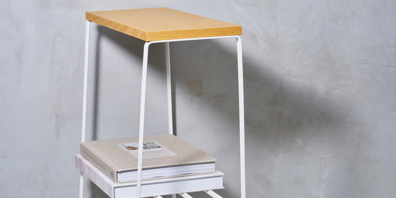 White steel End Table and wood tabletop with books stored on bottom rack. 