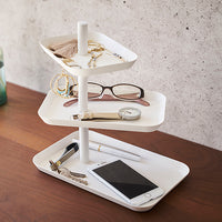 Yamazaki Home white jewelry stand holding glasses, watches. 