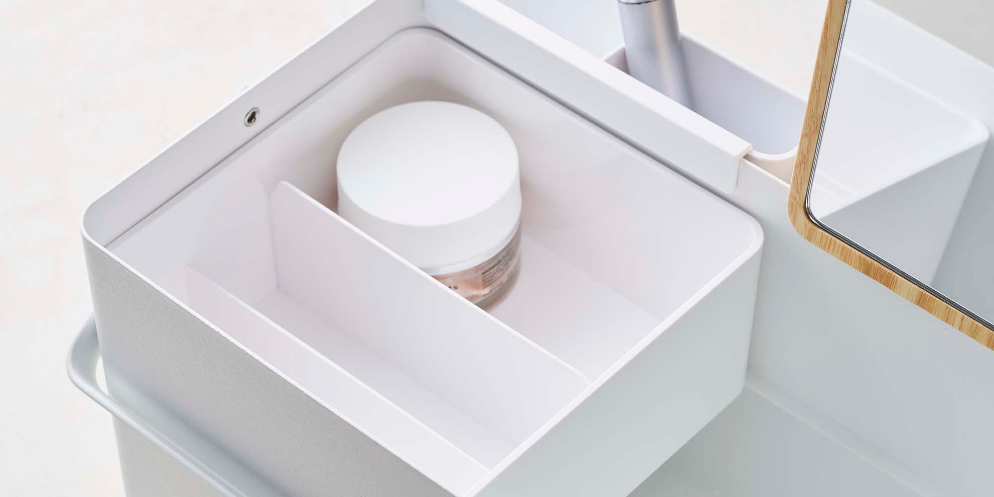 Makeup Organizer with Mirror holding glowy moisturizer. Closeup image.