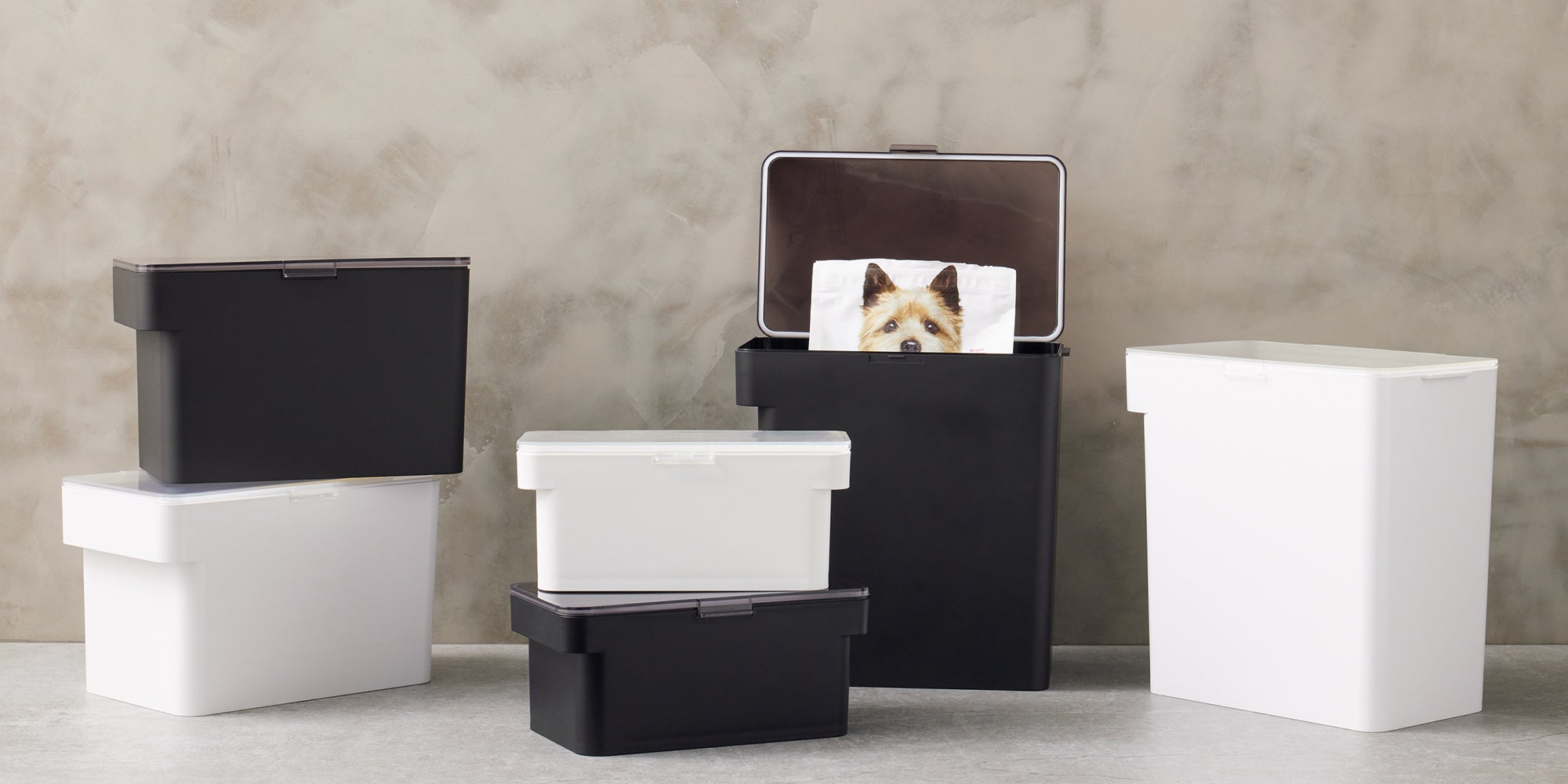 Six Airtight Pet Food Containers in various sizes. Three black containers and three white containers on display