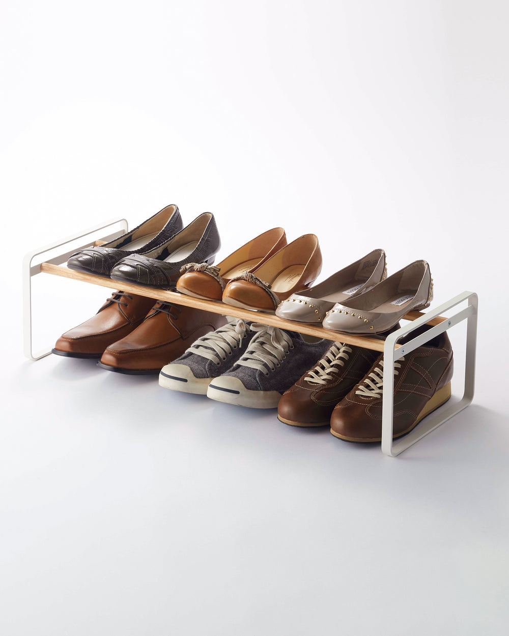 Yamazaki Home white shoe rack holding 6 pairs of shoes. 