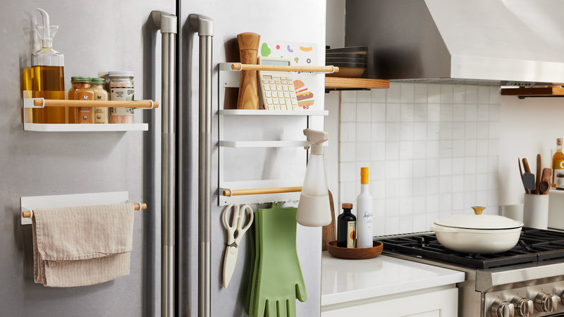  White Magnetic Organizers on kitchen fridge holding kitchen and cleaning equipment by Yamazaki Home.