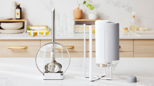 White Lid and Ladle Stand and Collapsible Bottle Dryer on a kitchen counter by Yamazaki Home.