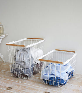 Side-by-side Yamazaki laundry baskets in a laundry room.
 view 5