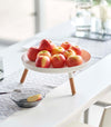 White Yamazaki Countertop Pedestal Tray with apples on top on a dining table